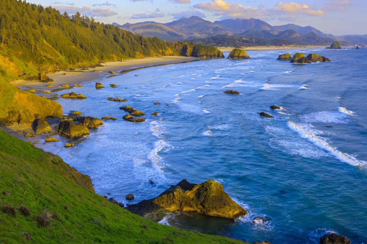 A panoramic view of the nearby coastline, featuring ocean waves, sandy beaches, and distant rock formations. The landscape is peaceful and expansive, highlighting the beauty of the local area and the possibilities for beach walks and outdoor adventures.